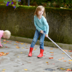 Child Sweeping Leaves